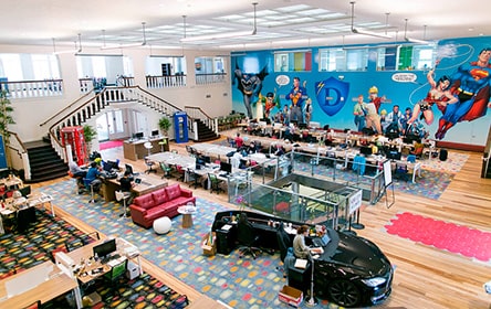 A large office with a mural on the wall, perfect for career growth.