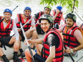 A group of people in life jackets rafting down a river, offering exciting job opportunities for adventurous individuals.