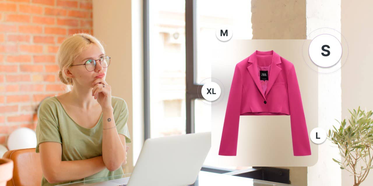 A woman is browsing through a pink blazer on a laptop, searching for sizing solutions.