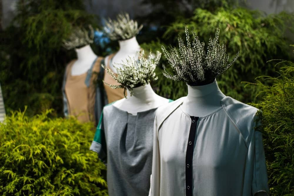Mannequins adorned with plants, reflecting the latest sustainable fashion trend for 2024. Ideal for apparel retailers looking to showcase eco-friendly styles.