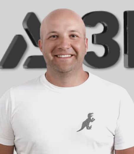 About Us: A bald man in a white t-shirt stands proudly in front of the A3 logo.