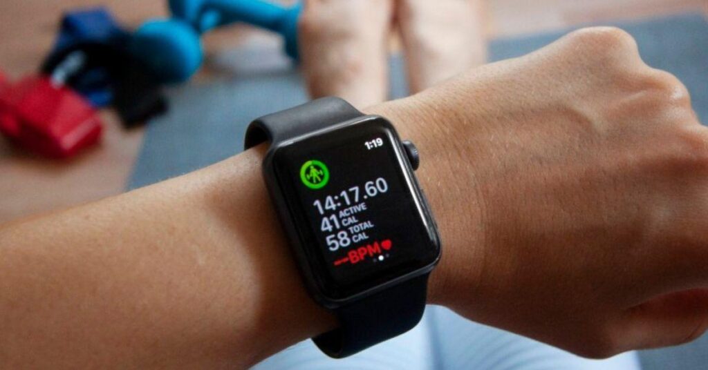An apple watch with top trends in fitness apps is shown on a person's wrist.