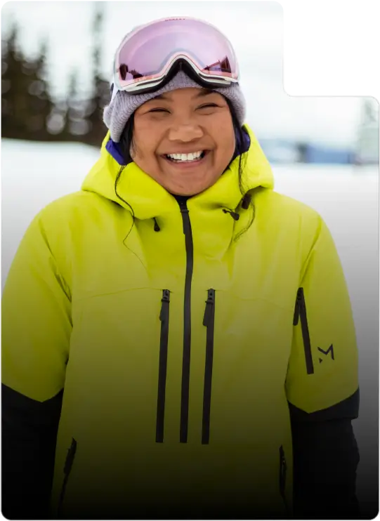 A girl in a yellow jacket and goggles graces the homepage of the website.