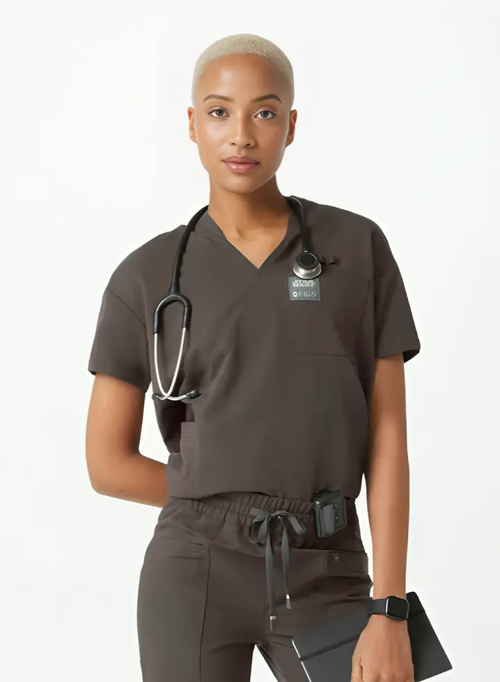 A healthcare professional wearing dark scrubs and a stethoscope stands confidently as part of the MT Redesign 2024.
