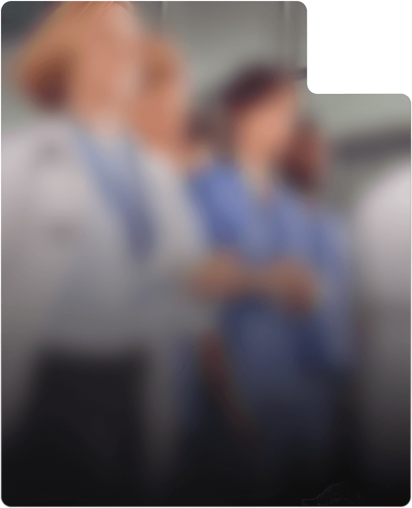 A blurry image of medical professionals wearing white and blue uniforms standing in a room, possibly after a FitXpress fitness workout session.
