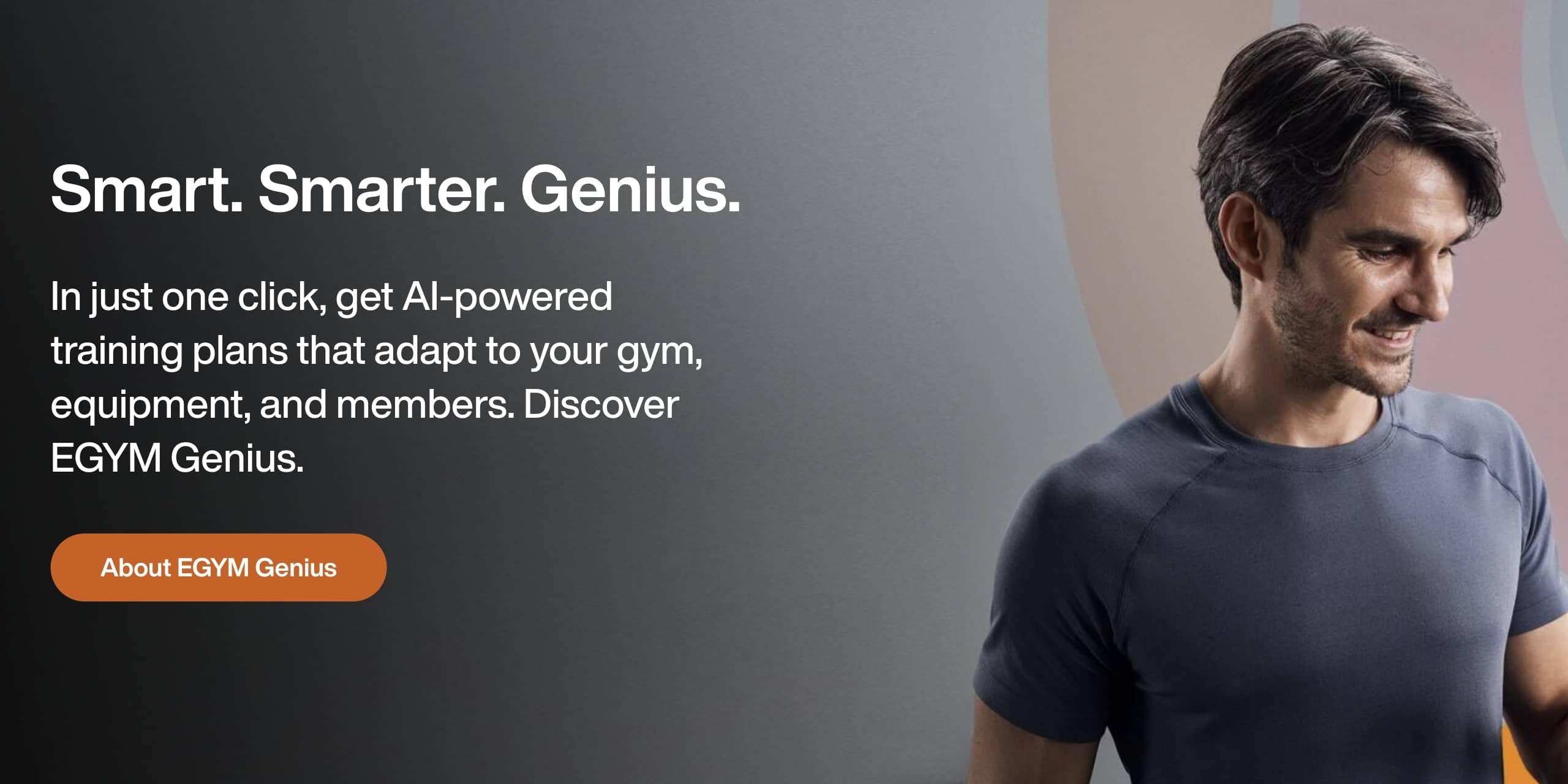 A man in a blue shirt looks down while standing next to text promoting EGYM Genius, an AI-powered tool for creating gym training plans. Discover why Fitness Tech Companies have ranked it among their top innovations for 2024. An orange button labeled "About EGYM Genius" is below the text.