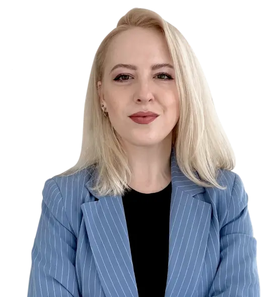 Professional portrait of a woman with blonde hair in a blue striped suit against a neutral background.