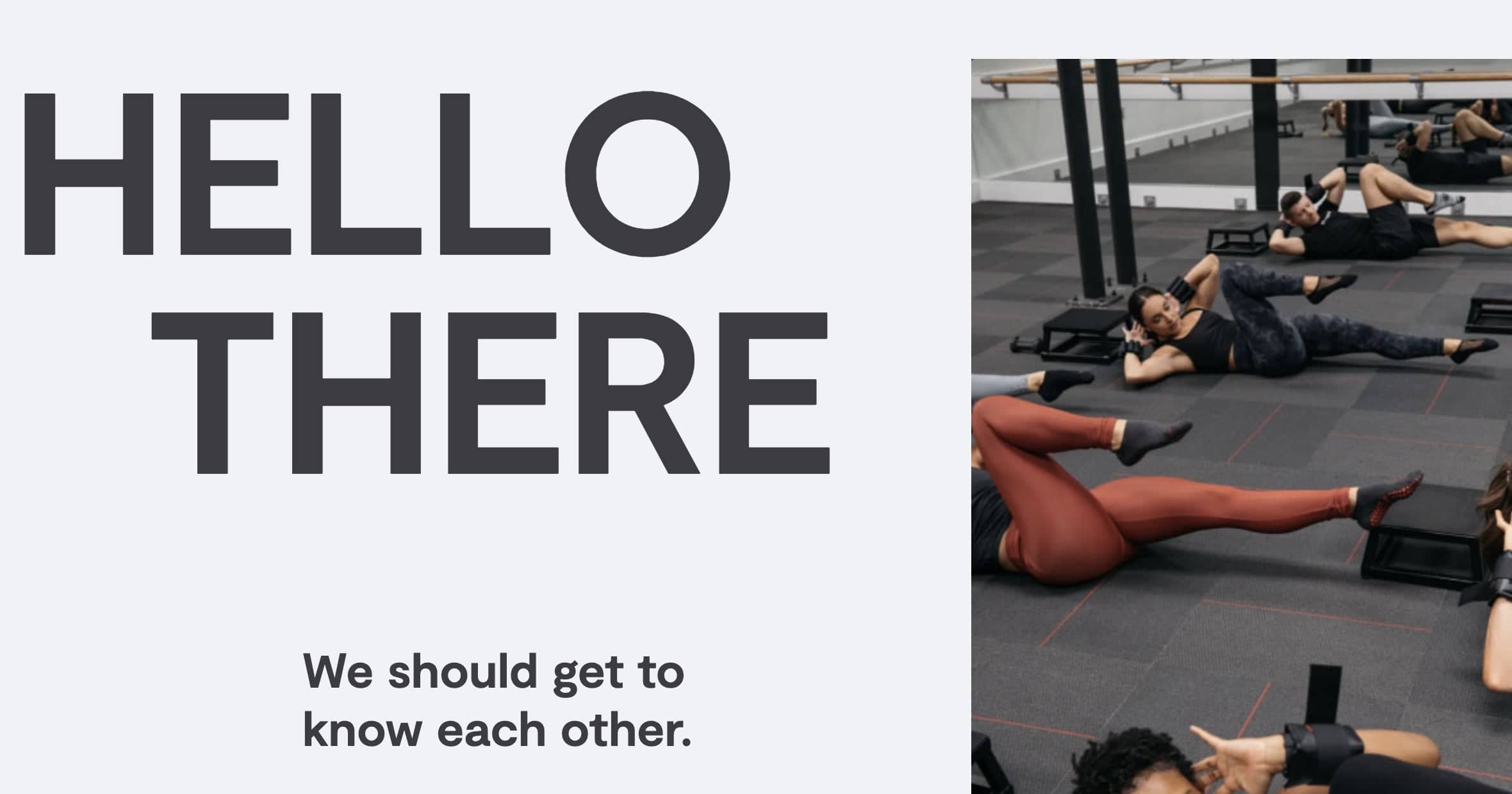 A group of people lies on exercise mats, performing leg lifts in a gym. Text on the left reads 'HELLO THERE. We should get to know each other.' As 2024 approaches, fitness tech companies are revolutionizing workouts like this one, making it easier to stay fit and connected.
