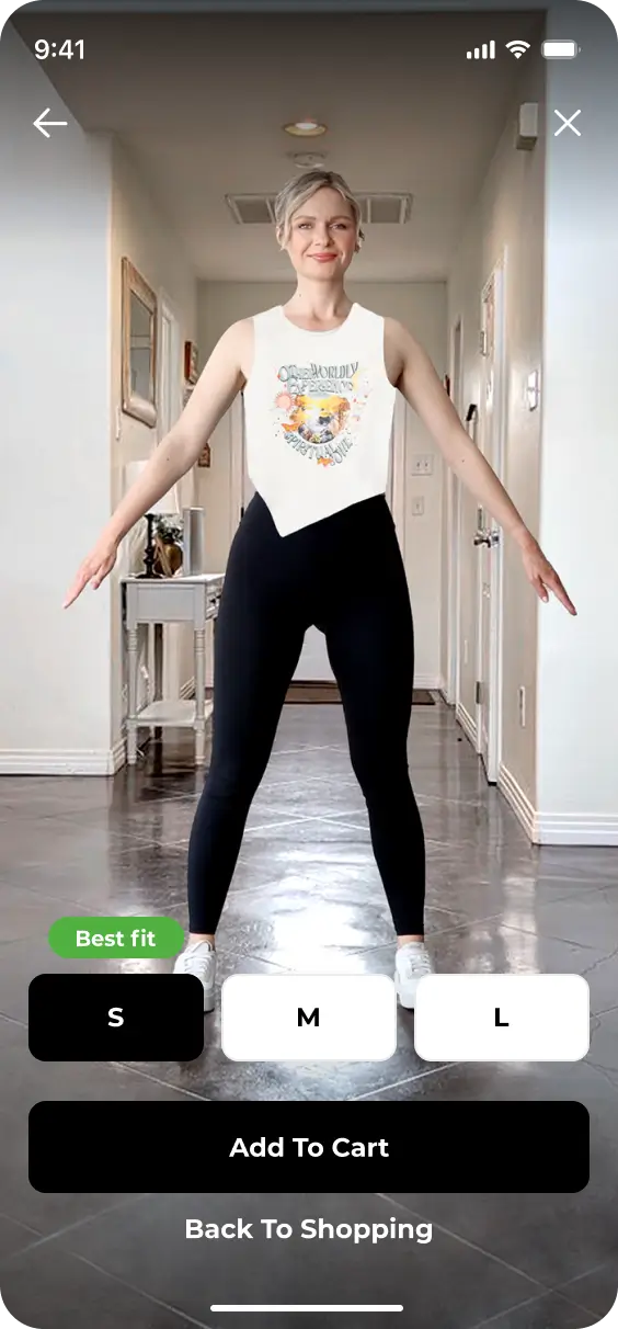 A person stands in a well-lit hallway, wearing a sleeveless top from the YourFit 2024 collection and black pants. Three size options (S, M, L) and buttons for "Add To Cart" and "Back To Shopping" are displayed on the screen.