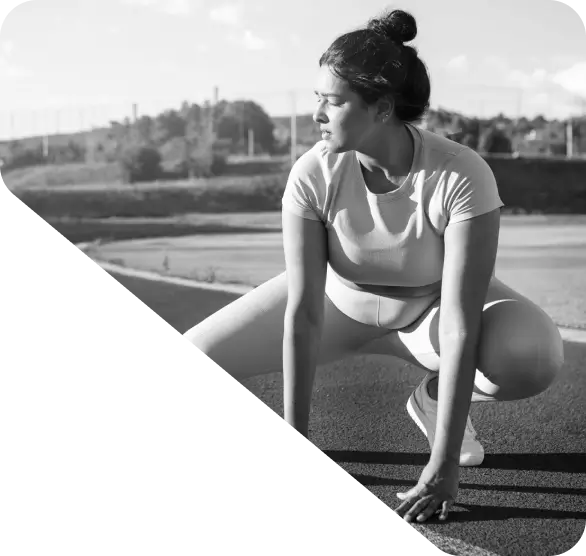 Homepage image: Woman in athletic wear stretching outdoors on a paved surface, with a blurred natural background, perfect for SEO and relevant keywords.