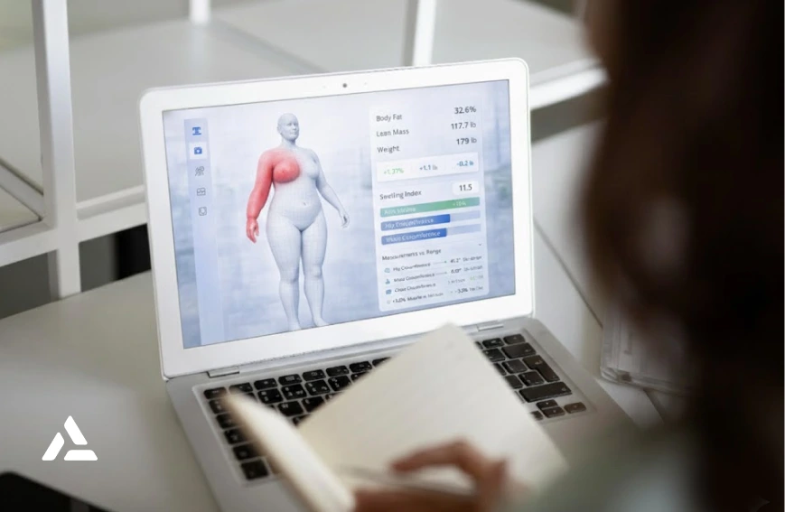 A person takes notes while viewing a computer screen displaying AI-powered 3D body scanning with health metrics and a highlighted chest area for early detection of breast cancer-related lymphedema.