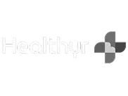“Healthyr” written in white next to a geometric cross logo with overlapping gray and white shapes on a light background, representing innovative Digital Health Programs designed to enhance well-being.